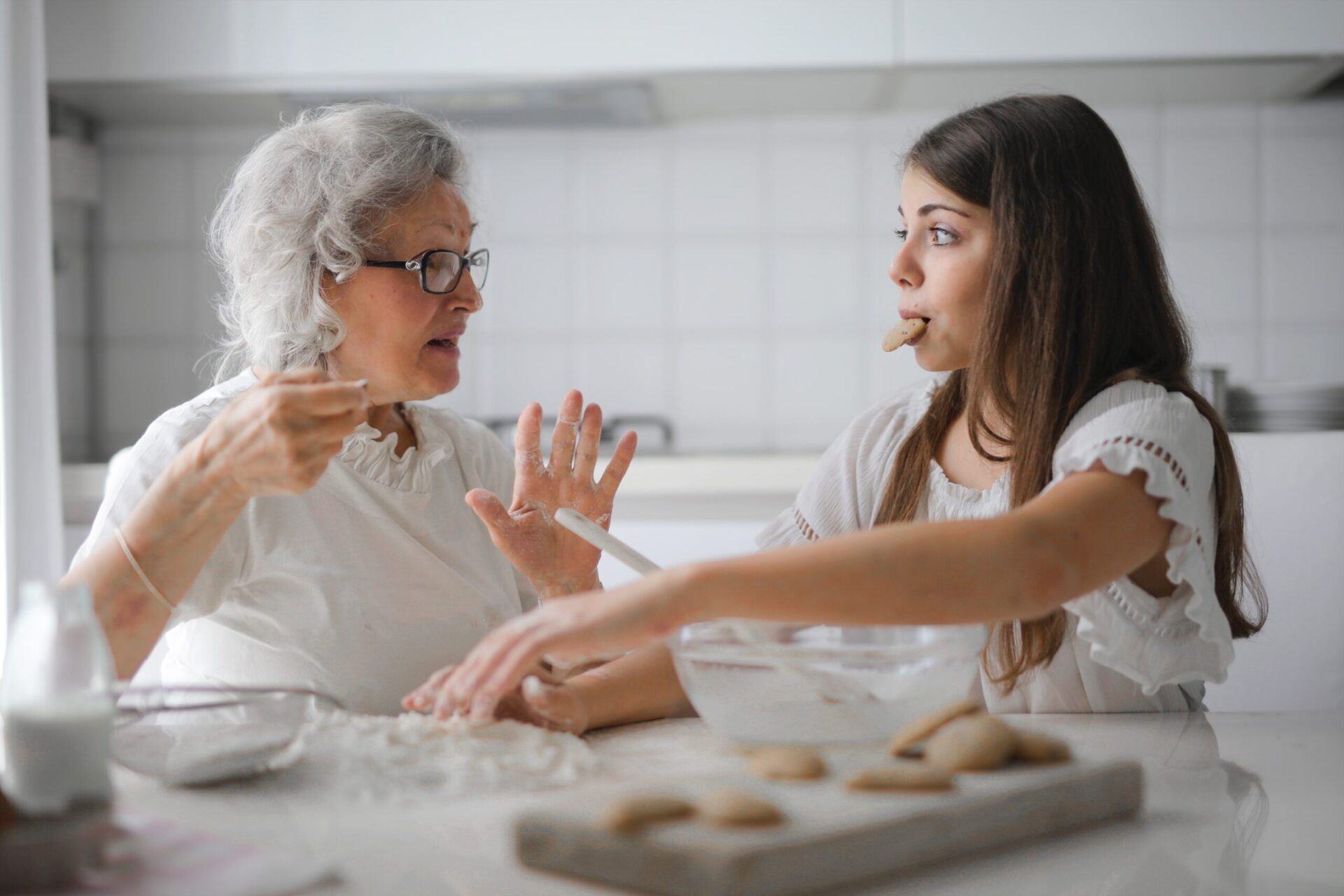 two women baking and eating cookies